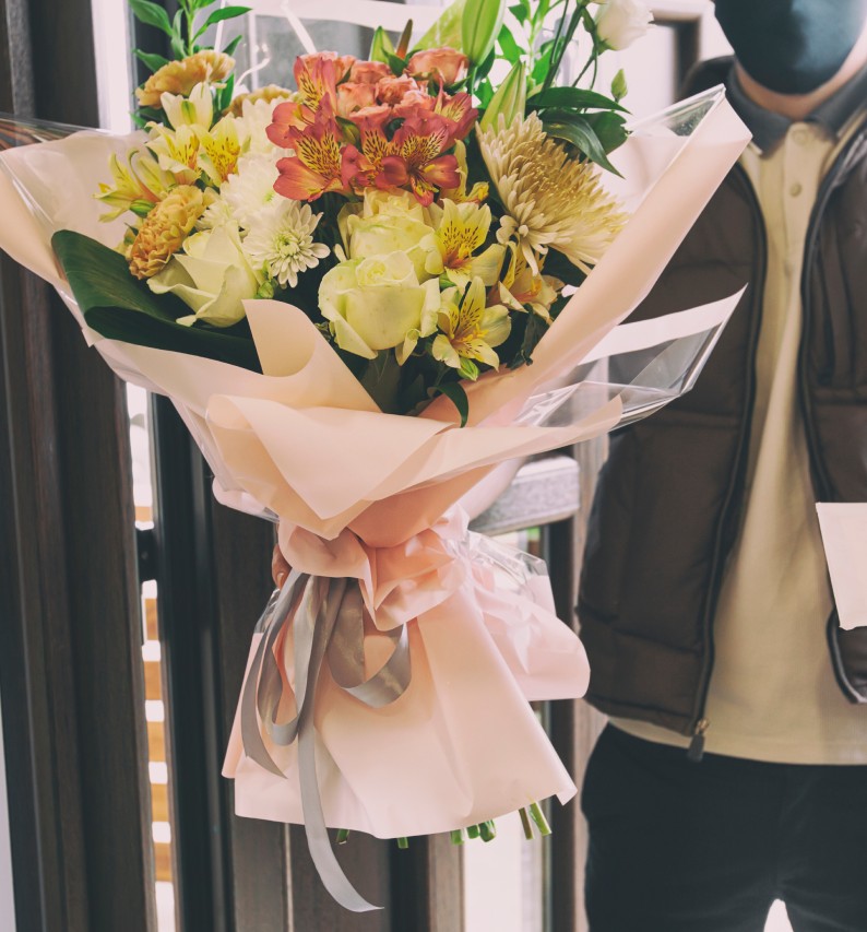 delivery driver holding flowers